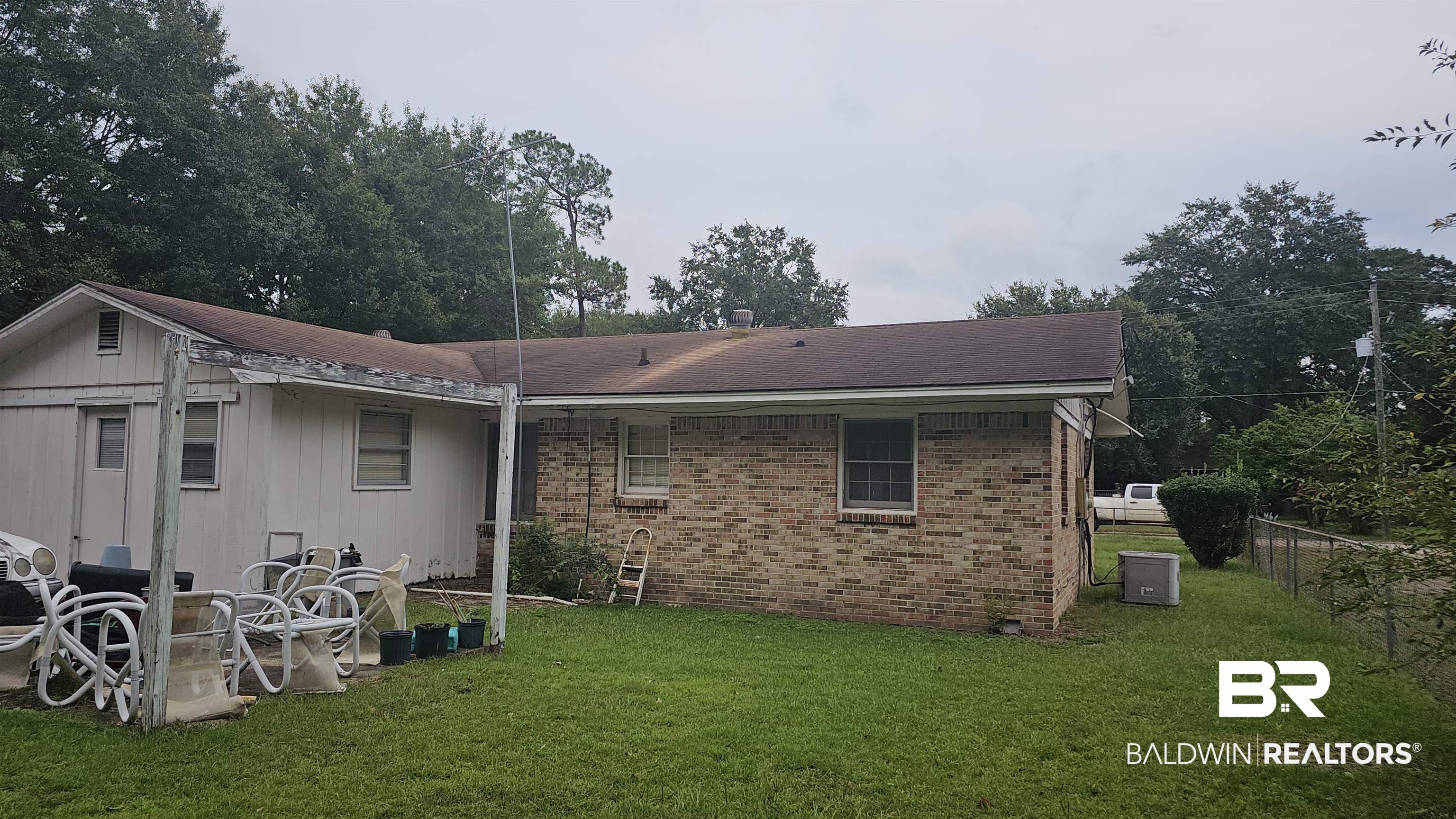 216 6th Avenue Atmore, AL 36502 - Photo 26 of 34 Rear view of house featuring a lawn