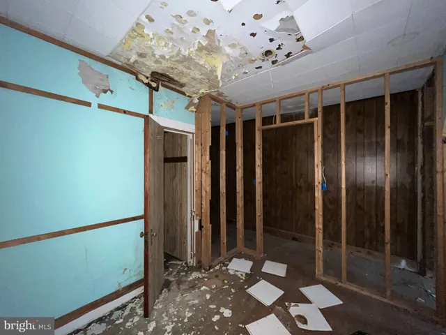 a living room with a large window and furniture