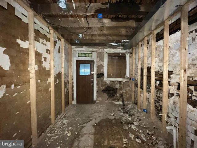 a view of a hallway with wooden walls