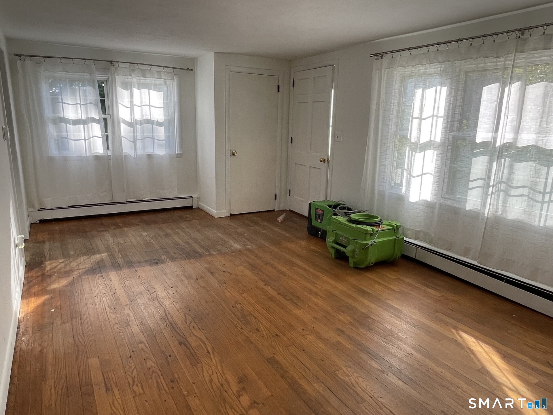 8 Prospect Hill Deep River, CT 06417 - Photo 3 of 16 an empty room with wooden floor and windows