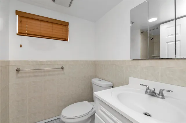 a bathroom with a sink a mirror and a toilet