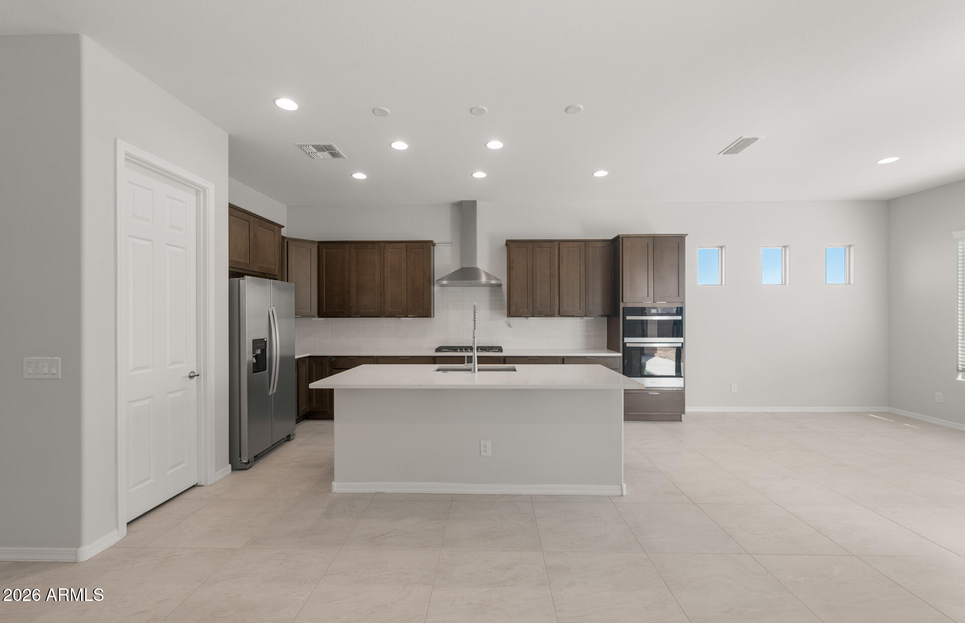 16081 West Bajada Road Surprise, AZ 85387 - Photo 11 of 28 a view of kitchen with stainless steel appliances kitchen island a sink a refrigerator and a stove