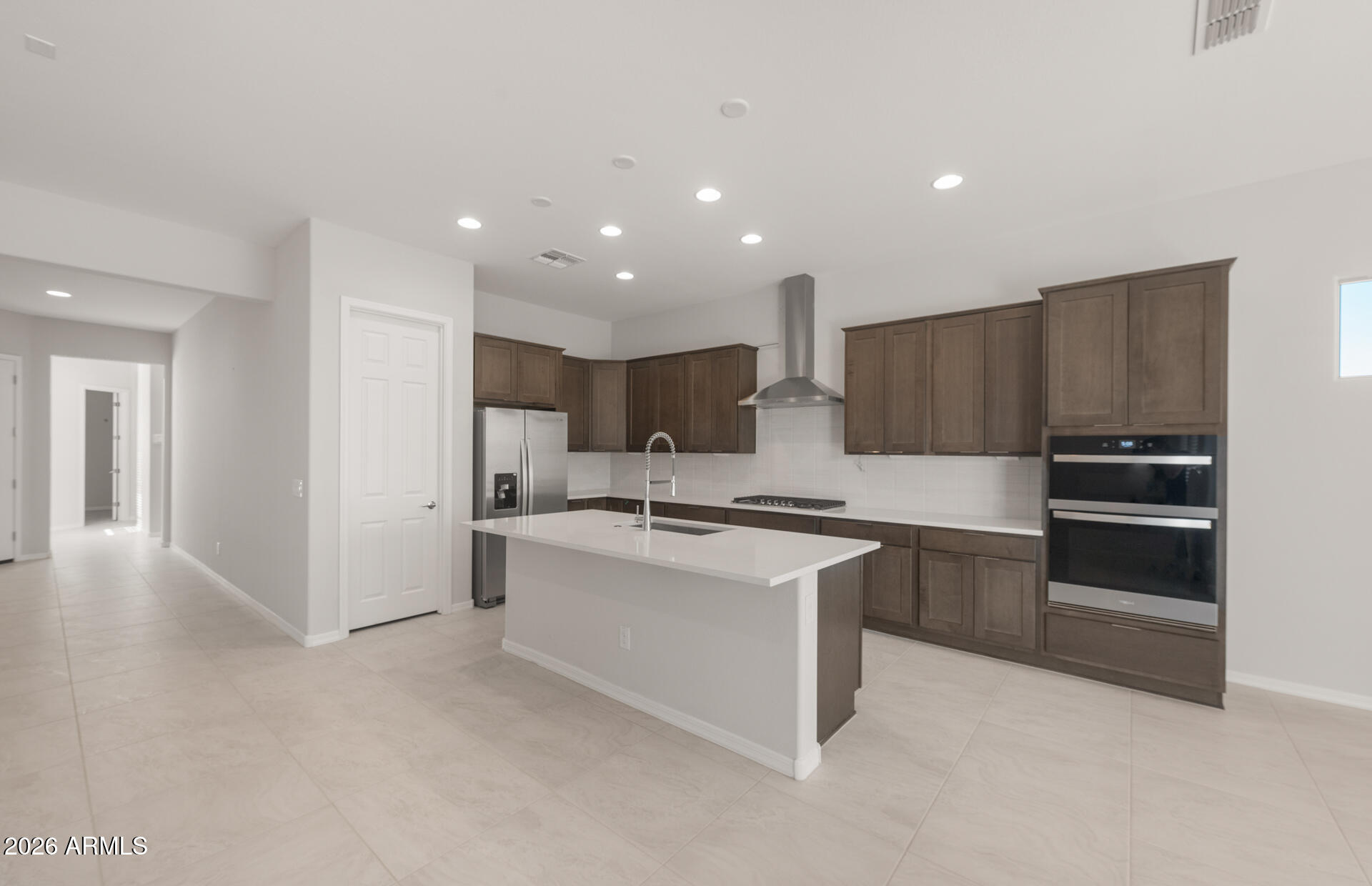 16081 West Bajada Road Surprise, AZ 85387 - Photo 12 of 28 a kitchen with stainless steel appliances a stove a sink and a refrigerator