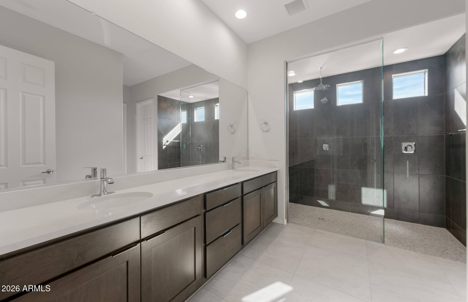 16081 West Bajada Road Surprise, AZ 85387 - Photo 20 of 28 a bathroom with a shower sink and mirror