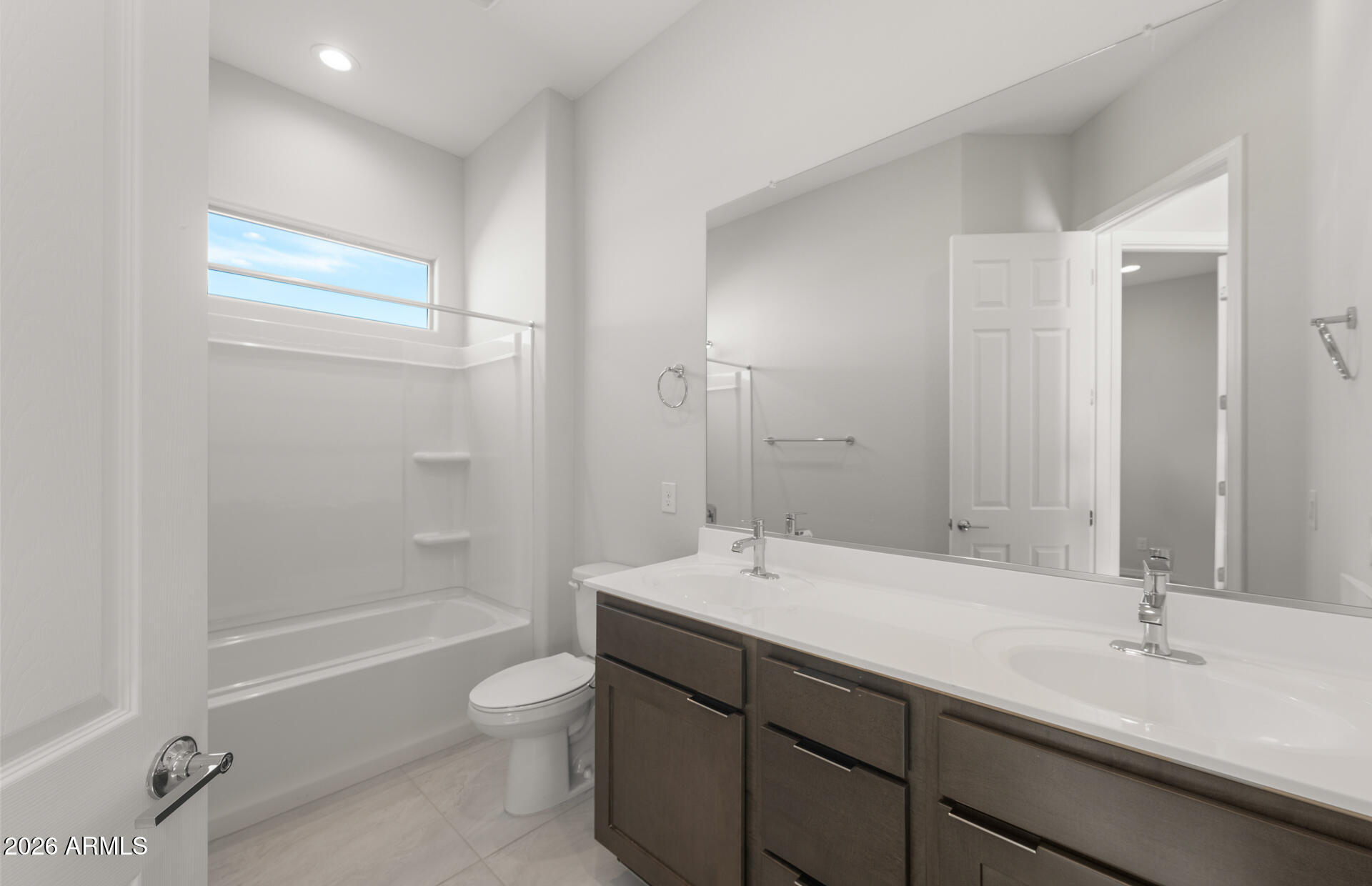 16081 West Bajada Road Surprise, AZ 85387 - Photo 4 of 28 a bathroom with a double vanity sink toilet mirror and bathtub