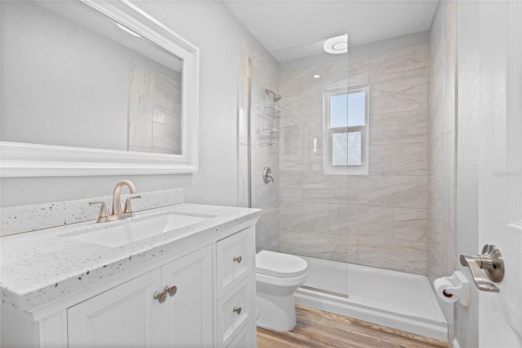 3801 42nd Street West Bradenton, FL 34205 - Photo 23 of 34 a bathroom with a sink a toilet and shower