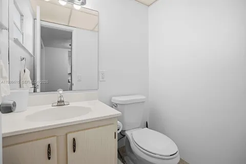 a bathroom with a sink a toilet and mirror