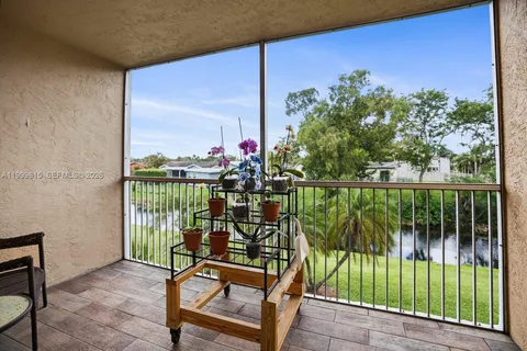 a view of a balcony with lake view and a potted plant