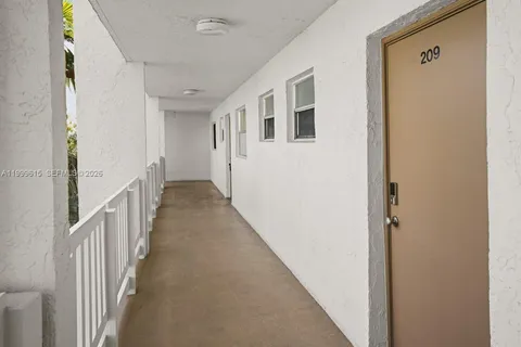 a view of a hallway with wooden floor and entryway