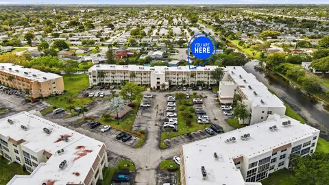 a aerial view of multiple houses with yard