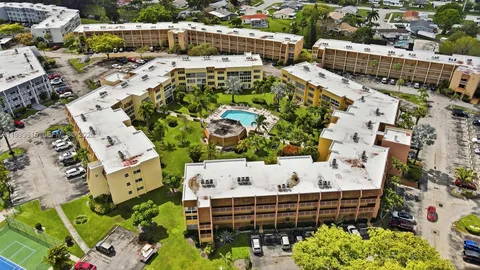 an aerial view of a house with a swimming pool and outdoor seating