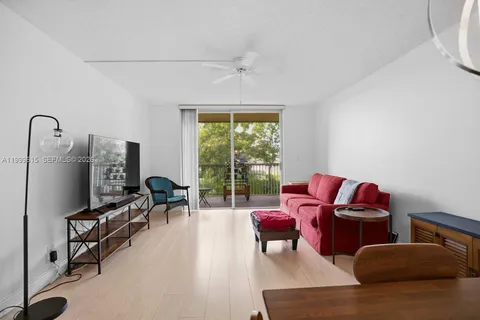 a living room with furniture fireplace and a large window