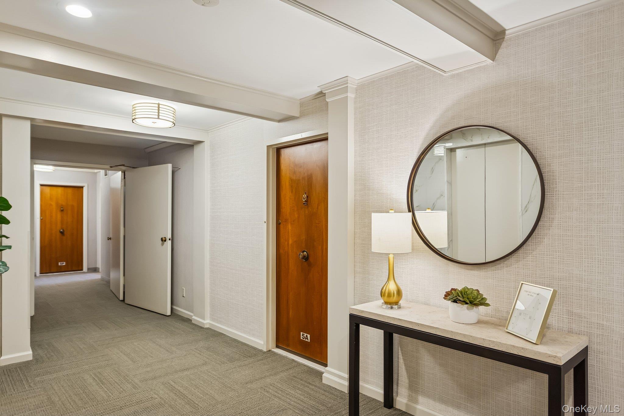 20 Old Mamaroneck Road, Unit 5Q White Plains, NY 10605 - Photo 13 of 18 a living room with furniture and a mirror
