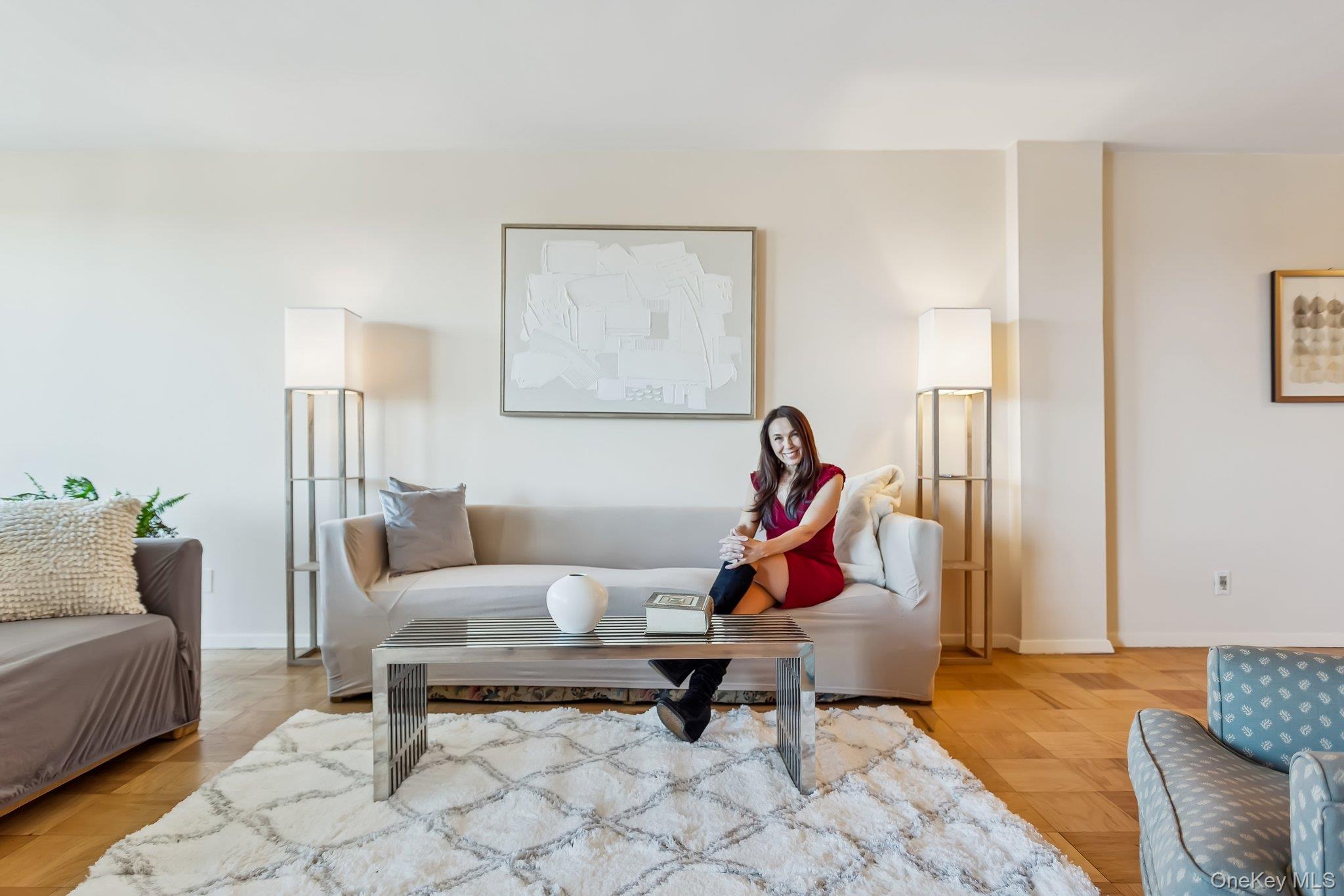 20 Old Mamaroneck Road, Unit 5Q White Plains, NY 10605 - Photo 5 of 18 a living room with furniture a rug and gym equipment