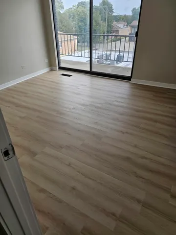 a kitchen with stainless steel appliances kitchen island granite countertop a refrigerator and a sink