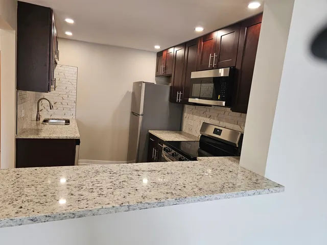 a kitchen with a sink and a refrigerator