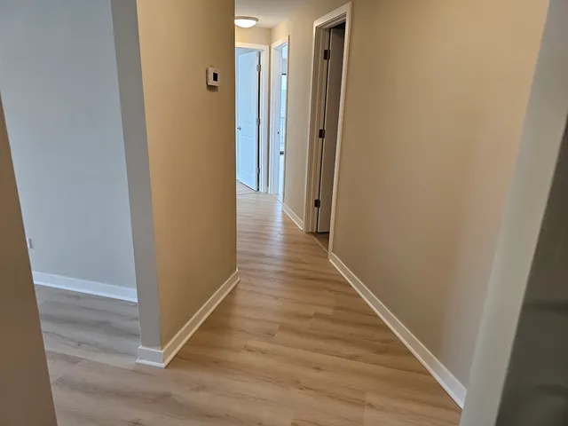 a view of wooden floor and brick wall