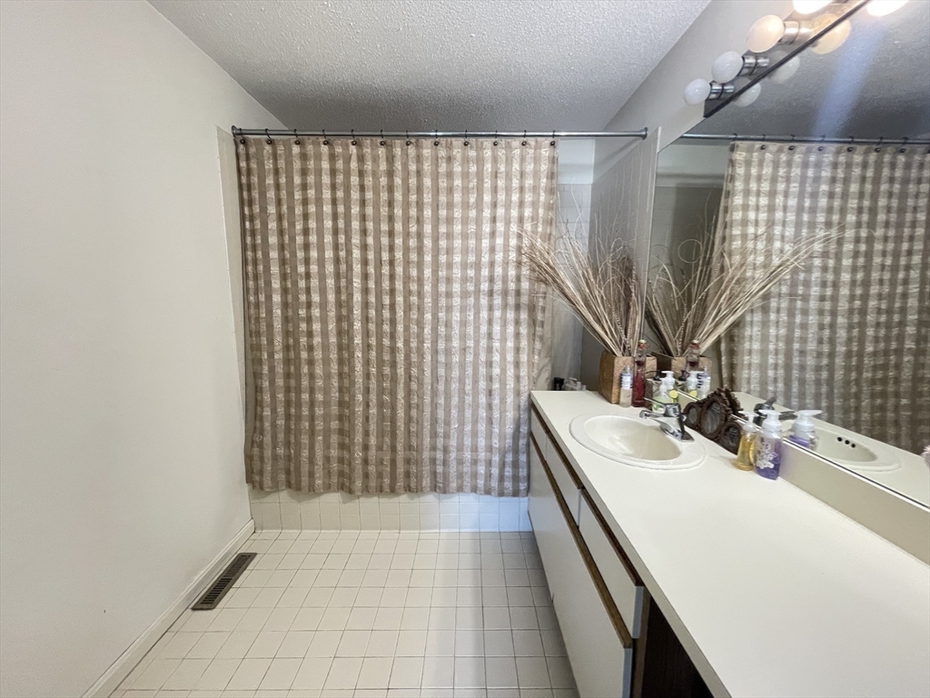 700 Shore Drive, Unit 6604 Fall River, MA 02721 - Photo 14 of 32 a bathroom with a sink a toilet and shower