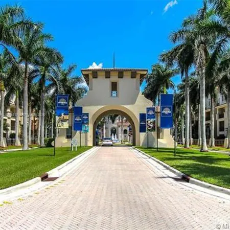 a view of a house with a yard and potted plants