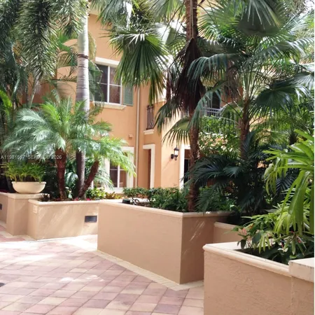 a view of a house with palm trees