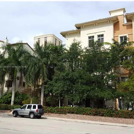 a car parked in front of a white house