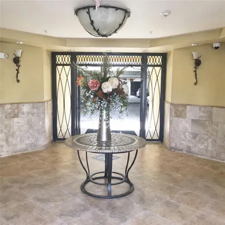 a dining room with furniture and chandelier