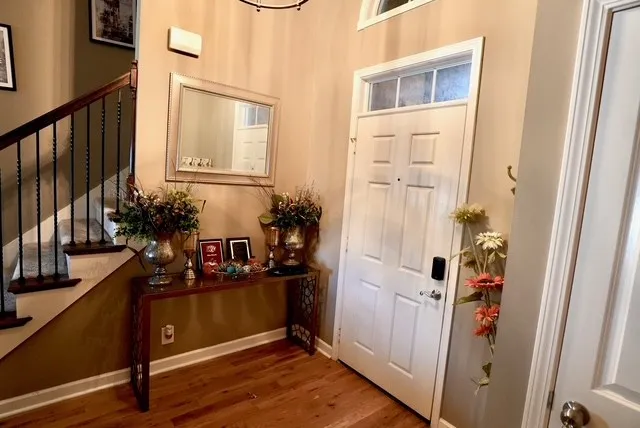 a view of a entryway with furniture and wooden floor