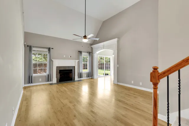 a view of an empty room with a fireplace and a window