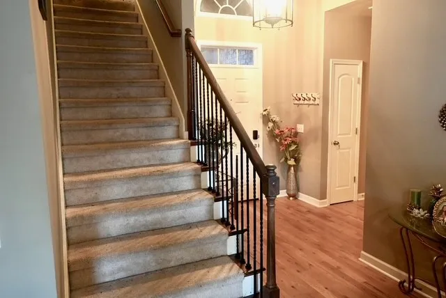 a view of entryway and gallery with wooden floor