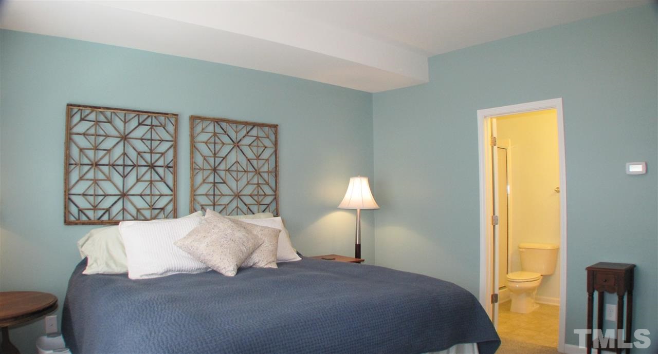 1428 Crafton Way Raleigh, NC 27607 - Photo 12 of 25 a bedroom with a bed and a night stand