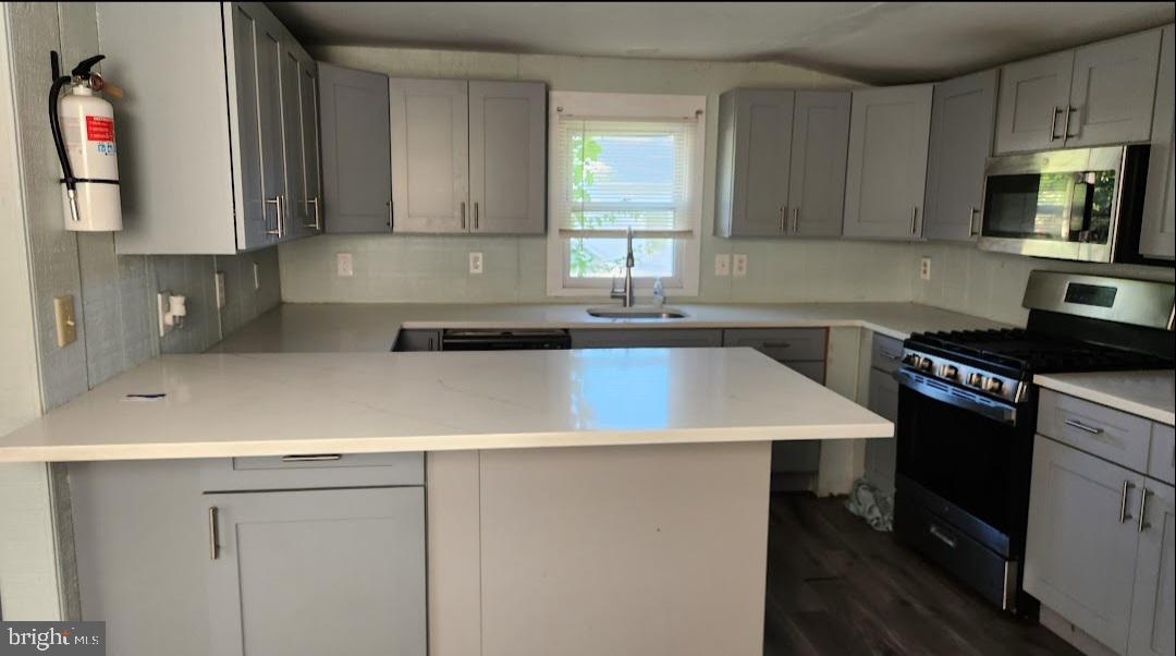 20 Church Landing Road Pennsville, NJ 08070 - Photo 4 of 22 a kitchen with a sink a stove and cabinets