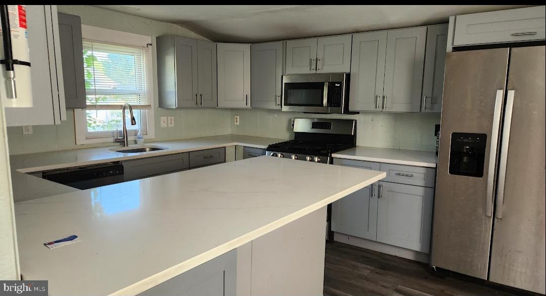 20 Church Landing Road Pennsville, NJ 08070 - Photo 5 of 22 a kitchen with a sink a microwave a refrigerator and cabinets
