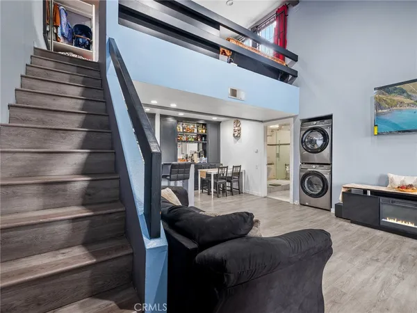 a living room with furniture and a stair