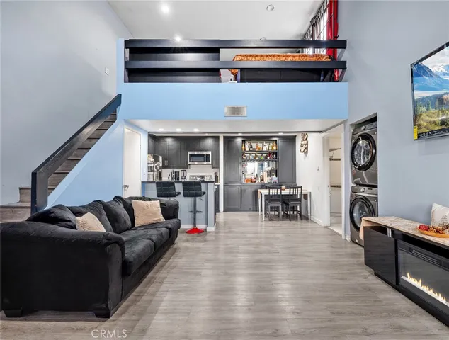 a kitchen with stainless steel appliances kitchen island granite countertop a refrigerator a stove a sink and a microwave