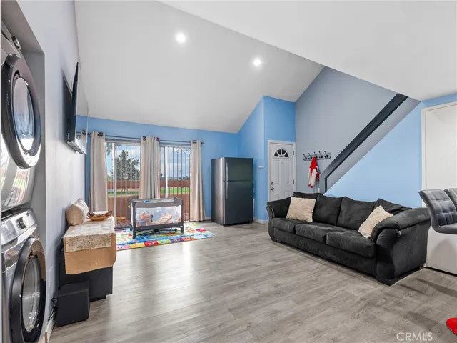 a kitchen with stainless steel appliances kitchen island granite countertop a refrigerator a stove a sink and a microwave