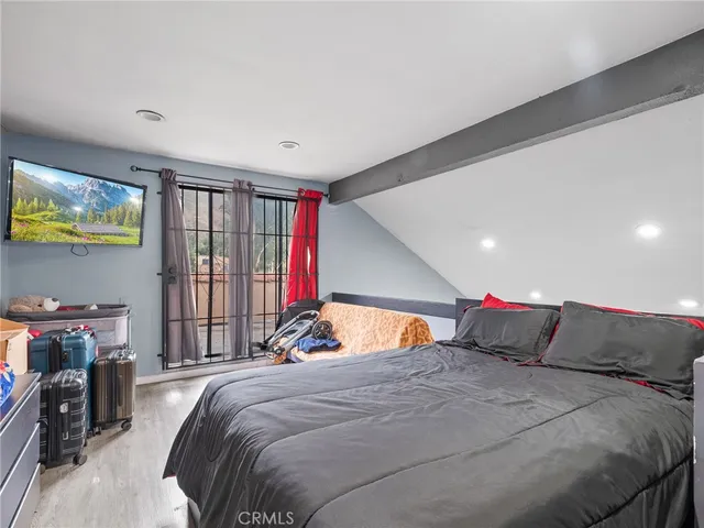 a bed room with a bed and a flat screen tv