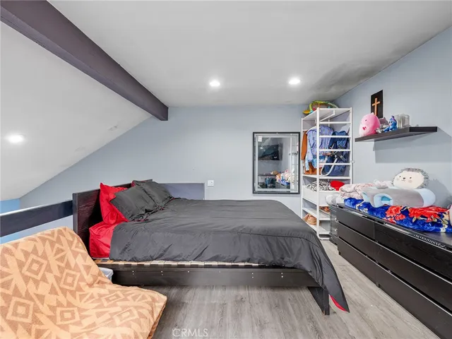 a bed sitting in a bedroom next to a window