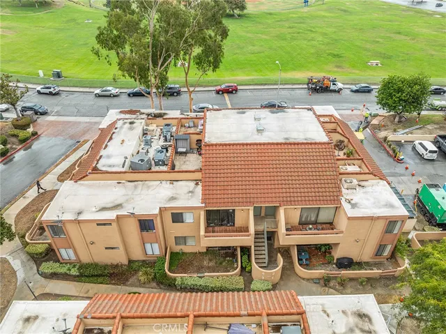 an aerial view of a house with a yard and trees