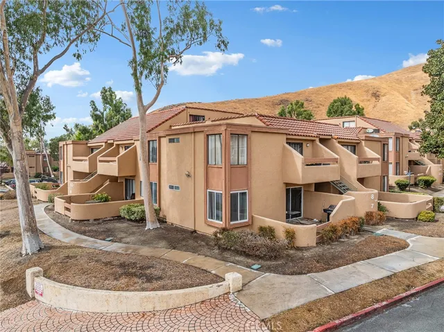 a view of a white house with a yard