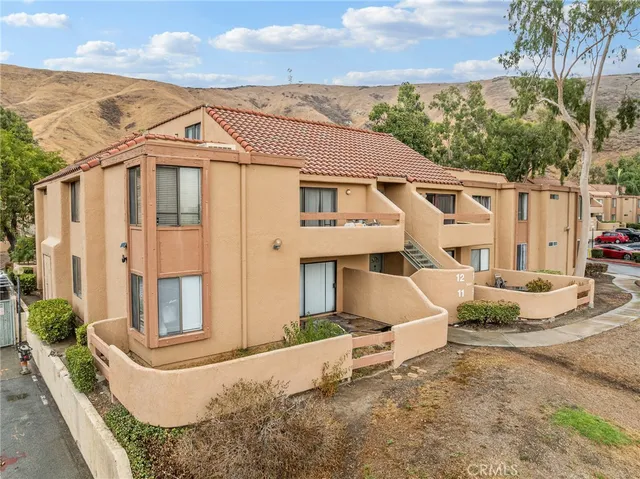 a living room with furniture and a stair
