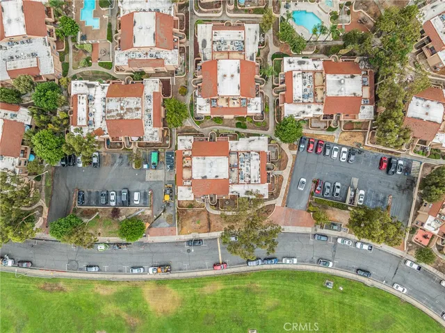 an aerial view of residential houses with outdoor space and swimming pool