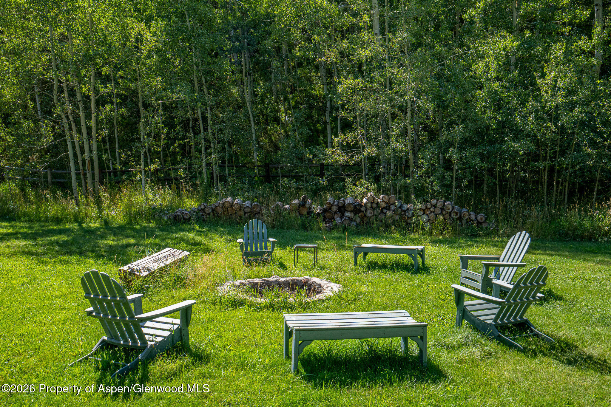 285 Conundrum Creek Road Aspen, CO 81611 - Photo 29 of 35 a swimming pool with barbeque pool outdoor seating and green yard
