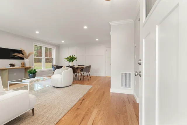 a living room with furniture a table and a potted plant