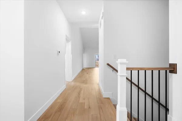 a view of a hallway with wooden floor