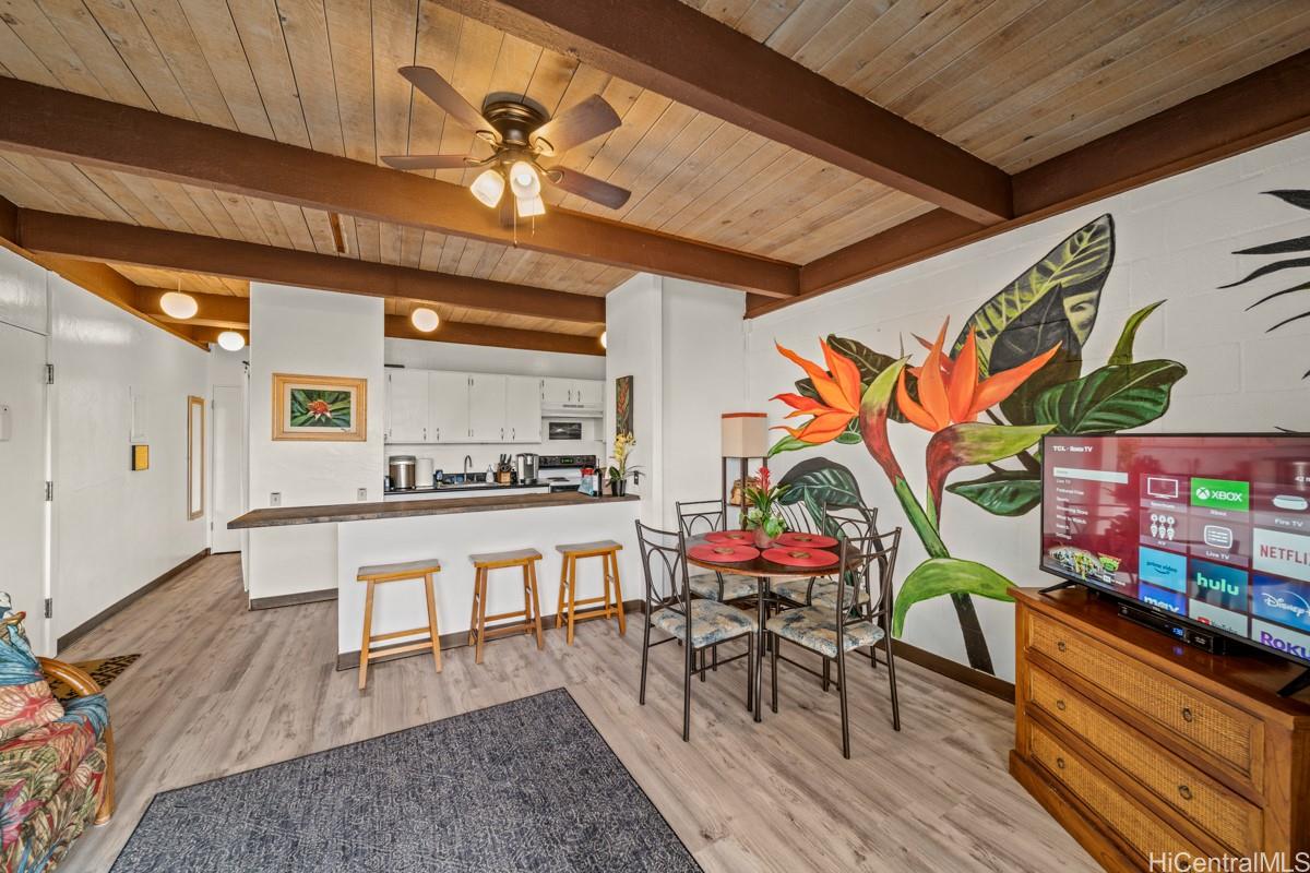 a dining room with furniture and wooden floor