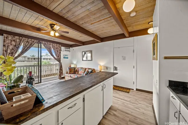 a kitchen with a stove and a wooden floor