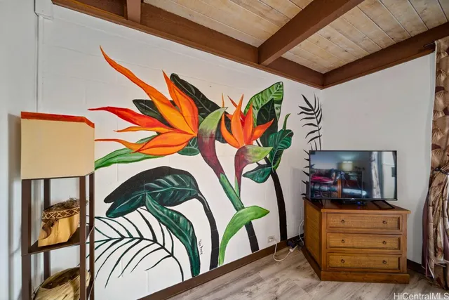 a bedroom with a bed and a painting on the wall