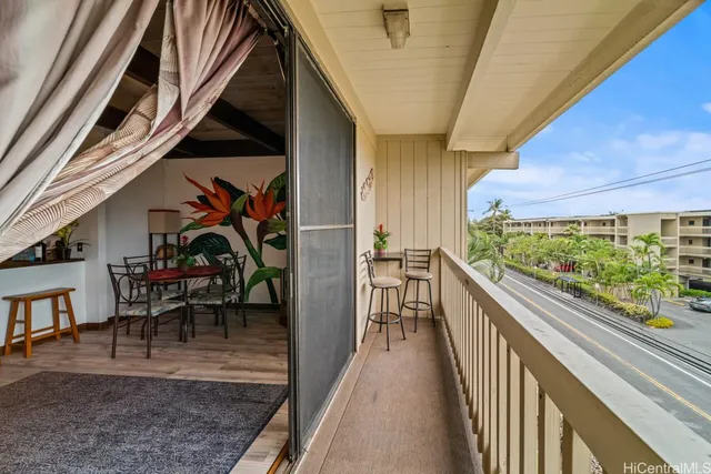 a view of a chairs and table in the balcony