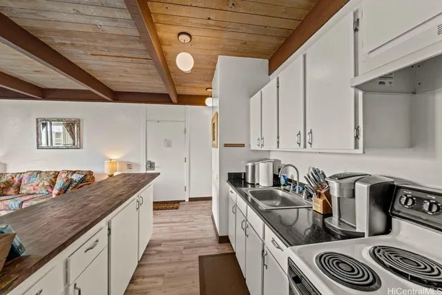 a kitchen with granite countertop a sink and cabinets