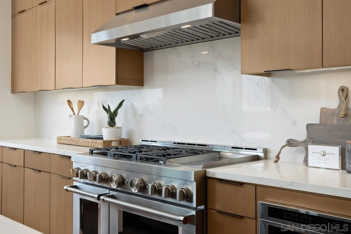 1748 Whaley Street Oceanside, CA 92054 - Photo 11 of 38 a kitchen with granite countertop a stove and a sink